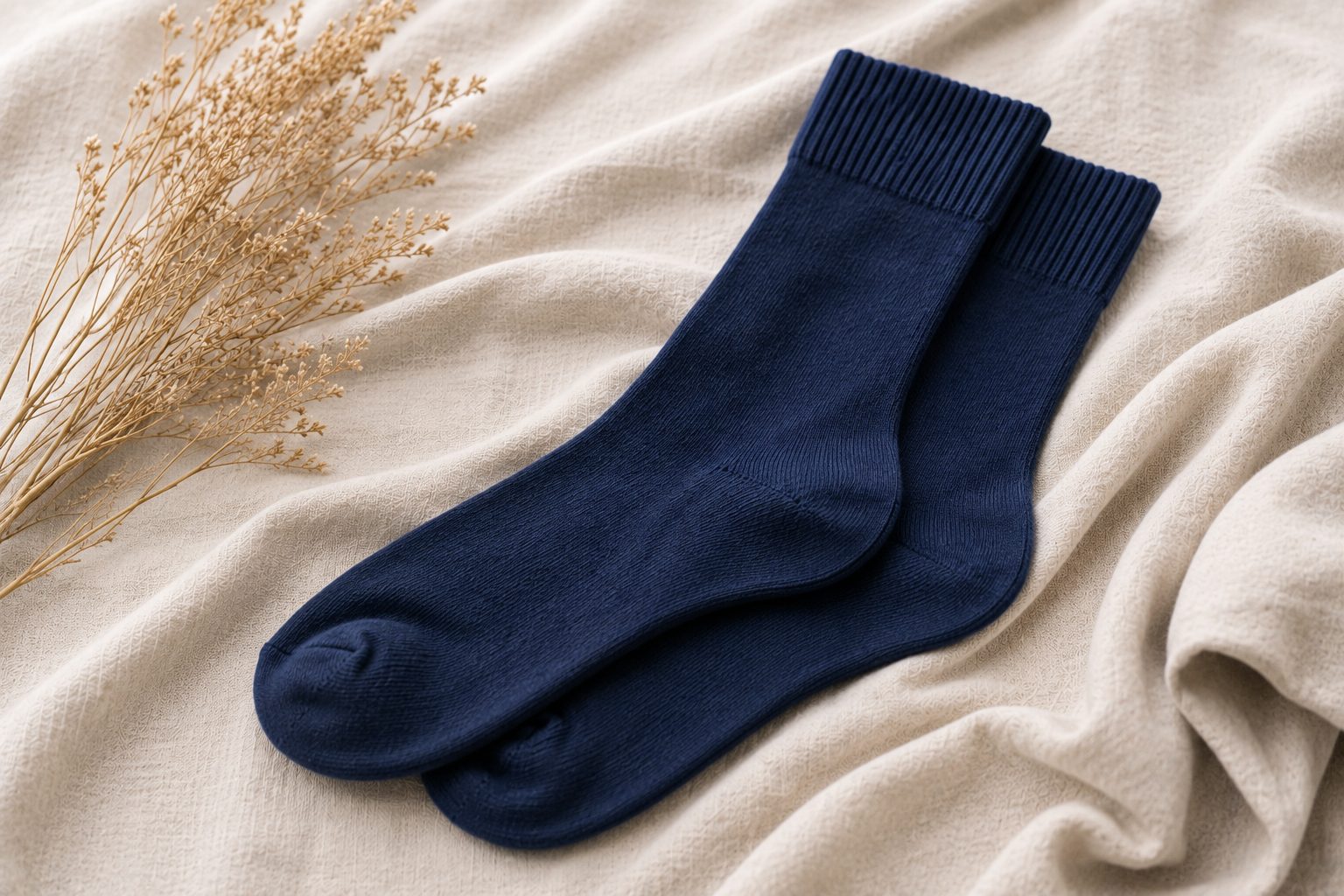 A pair of soft grey Kilde comfort socks laid flat, showing the wide non-binding cuff and flat toe seam